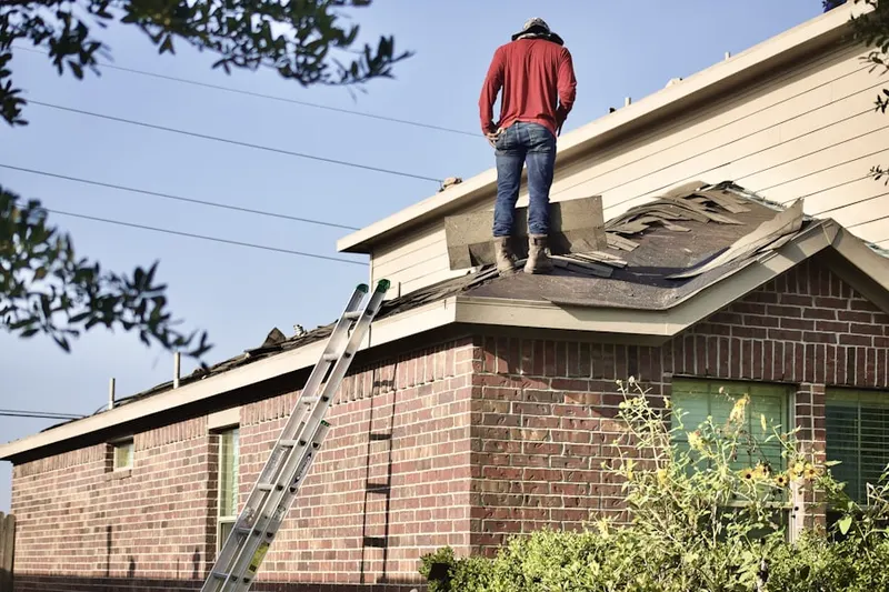 Professional roofer working on a residential roof in Aquia Harbour